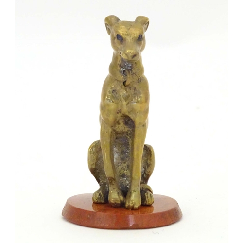 963 - A late 19th / early 20thC brass model of a seated dog on a circular hardstone base. Approx. 2 1/2