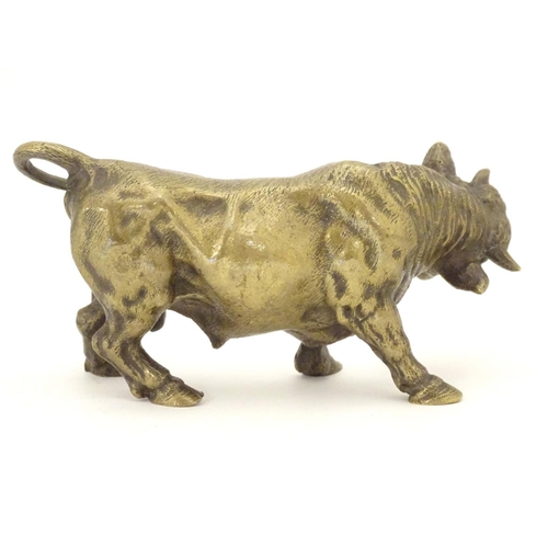 967 - An early 20thC brass model of a charging bull, with a post engraved From Harry Granger, Hitherto, 19... 