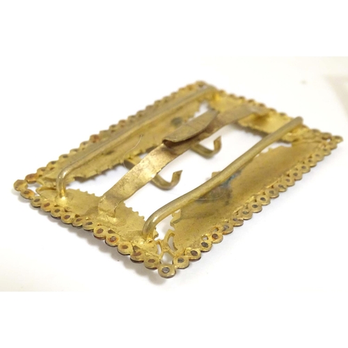 972 - A gilt metal buckle with stylised dragon detail and cut steel border. Together with a silver plate b... 