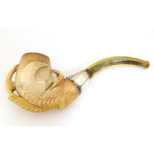 980 - An early 20thC cased carved meerschaum pipe, the bowl formed as an eagle talon, joined to the amber ... 