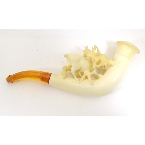 981 - An early 20thC cased ladies' carved meerschaum pipe, the bowl formed as a stag amongst foliage, with... 