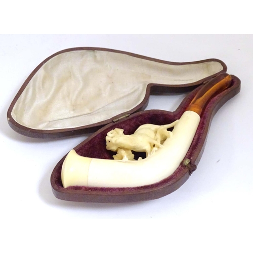 981 - An early 20thC cased ladies' carved meerschaum pipe, the bowl formed as a stag amongst foliage, with... 