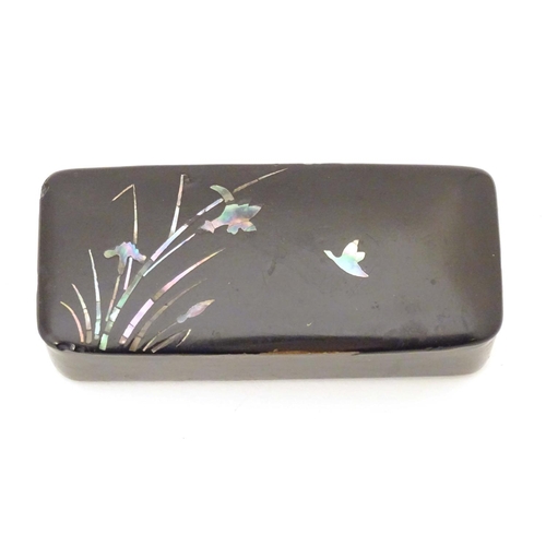 984 - A late 19th / early 20thC papier mache snuff box with inlaid mother of pearl detail depicting flight... 