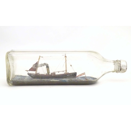 999 - A 20thC ship in a bottle / diorama depicting Kindred Star LT177, a steam trawler boat at sea. Approx... 