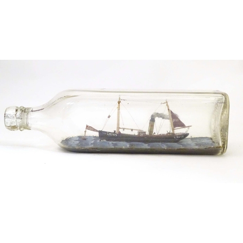 999 - A 20thC ship in a bottle / diorama depicting Kindred Star LT177, a steam trawler boat at sea. Approx... 