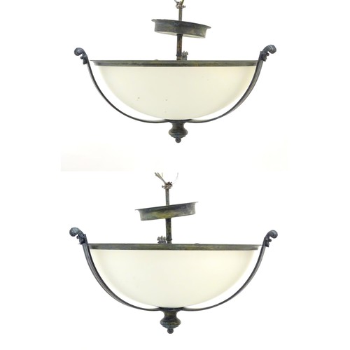 1202 - A pair of ceiling lights with frosted glass domed shades and metal strap work 18