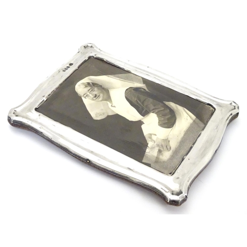 234 - A photograph frame with silver surround. Hallmarked Birmingham 1912 maker Jones & Crompton. 7