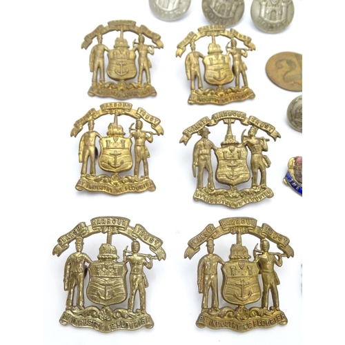 569 - Militaria: a collection of 20thC military badges, including an early 20thC white metal dog tag (insc... 