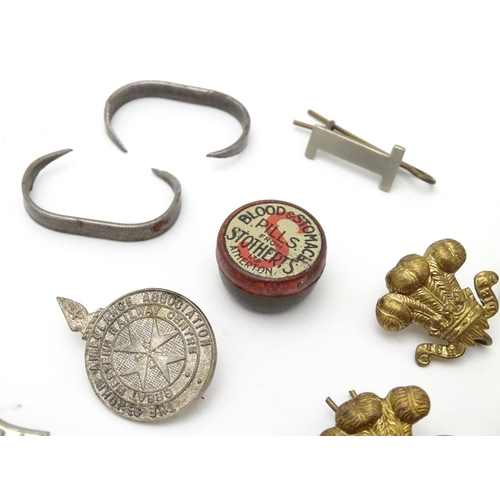 569 - Militaria: a collection of 20thC military badges, including an early 20thC white metal dog tag (insc... 