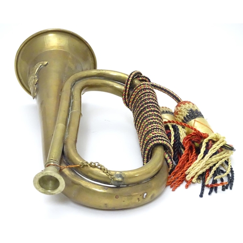 570 - Militaria: a 20thC British Army (Royal Artillery) bugle, constructed of copper and brass with regime... 