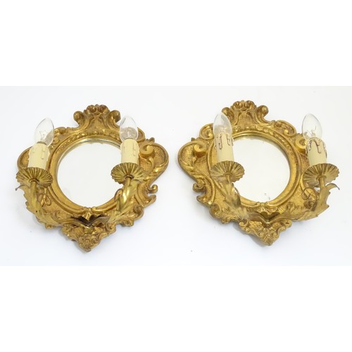 1204 - A pair of  late 20thC twin branch girandole wall lights with carved and moulded frame to mirror back... 