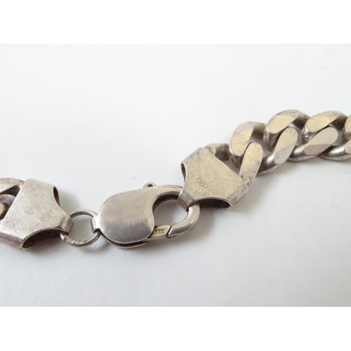 541 - A Gentleman's silver necklace and bracelet of chain form. The necklace 20