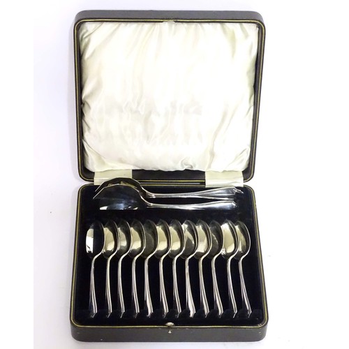 223A - A cased silver set of 12 spoons and 2 servers. Hallmarked Sheffield 1924 maker Cooper Brothers & Son... 