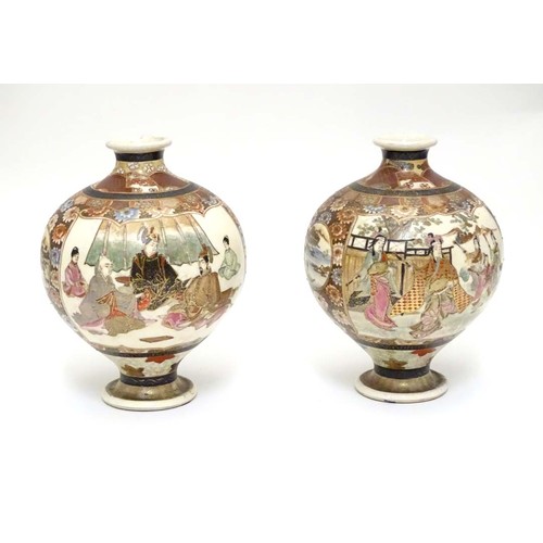 19 - A pair of Japanese Satsuma vases of globular form in the Kutani style with flared rims and feet. The... 