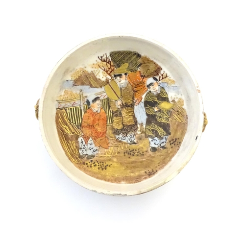 26 - A Japanese Satsuma pot and cover. The cover decorated with a landscape scene with two scholar figure... 