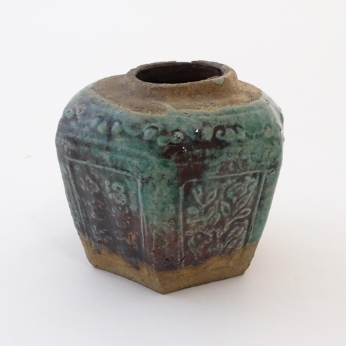 37 - A Chinese hexagonal Shiwan ginger jar / vase with moulded floral and foliate detail with a blue / gr... 