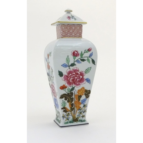 133 - A Portuguese Vista Alegre lidded vase with hand painted floral decoration. Approx. 10 1/4