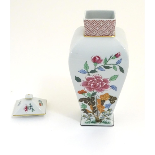 133 - A Portuguese Vista Alegre lidded vase with hand painted floral decoration. Approx. 10 1/4