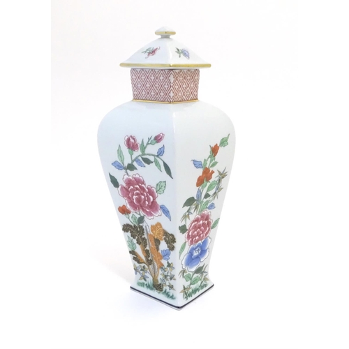 133 - A Portuguese Vista Alegre lidded vase with hand painted floral decoration. Approx. 10 1/4