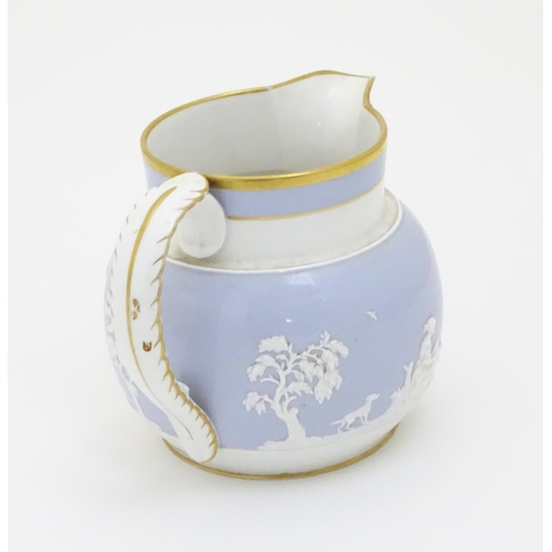 136 - A 19thC lilac jug with relief figural detail and gilt highlights. Approx. 5 1/2