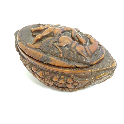 852 - A Continental carved nut snuff box, the hinged lid decorated with a horse and a man carrying a woman... 