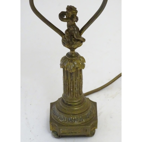 1516 - A mid to late 20thC brass table lamp, formed as a Corinthian column surmounted by a putto. 22