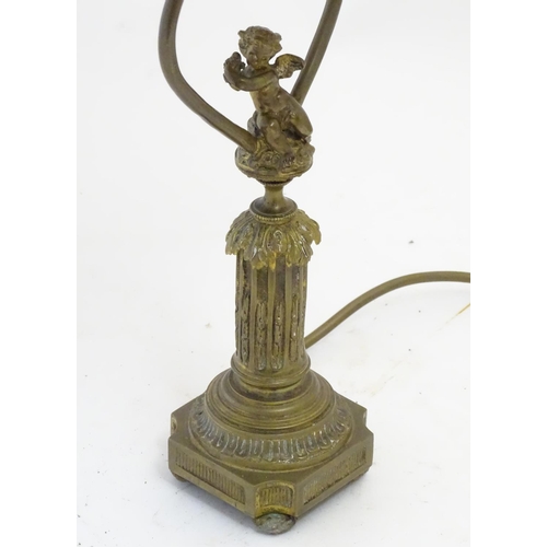 1516 - A mid to late 20thC brass table lamp, formed as a Corinthian column surmounted by a putto. 22