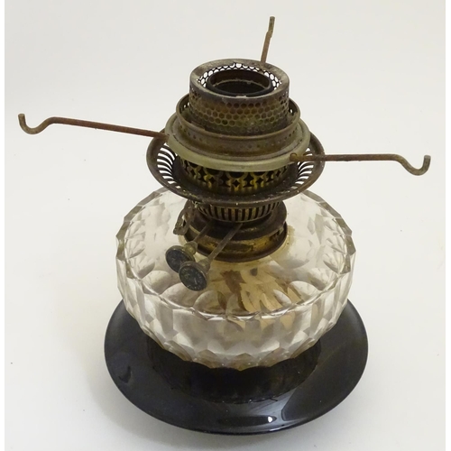 1524 - A 19thC oil lamp, the black glass base with facet cut glass reservoir and white milk glass shade. Th... 