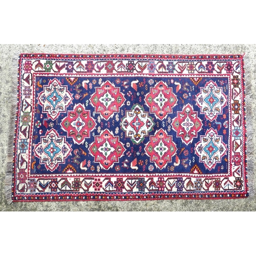 1531 - Carpet / Rug : A rug with blue ground and cream ground border, decorated with geometric vignettes an... 