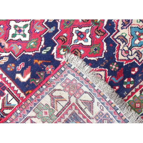 1531 - Carpet / Rug : A rug with blue ground and cream ground border, decorated with geometric vignettes an... 