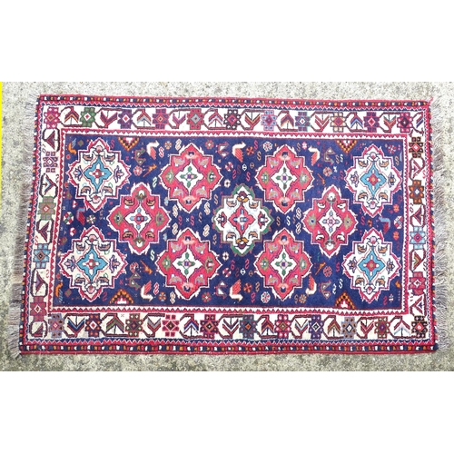 1531 - Carpet / Rug : A rug with blue ground and cream ground border, decorated with geometric vignettes an... 