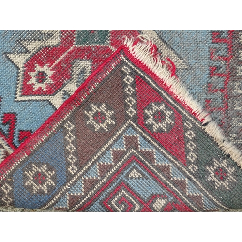 1533 - Carpet / Rug : A runner with pale blue ground with banded geometric red, brown and bright blue detai... 