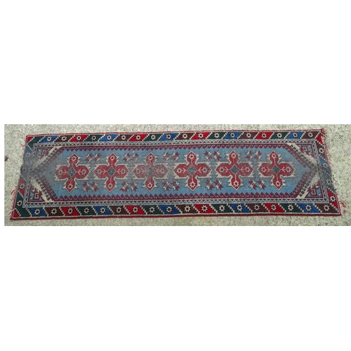 1533 - Carpet / Rug : A runner with pale blue ground with banded geometric red, brown and bright blue detai... 