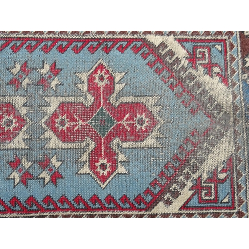 1533 - Carpet / Rug : A runner with pale blue ground with banded geometric red, brown and bright blue detai... 