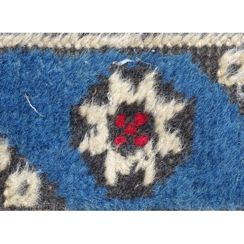 1533 - Carpet / Rug : A runner with pale blue ground with banded geometric red, brown and bright blue detai... 