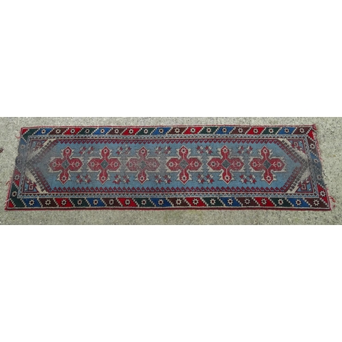 1533 - Carpet / Rug : A runner with pale blue ground with banded geometric red, brown and bright blue detai... 