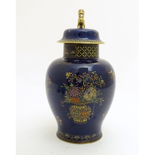 100 - A Wiltshaw and Robinson Carlton Ware baluster vase and cover decorated with flowers, with a blue gro... 