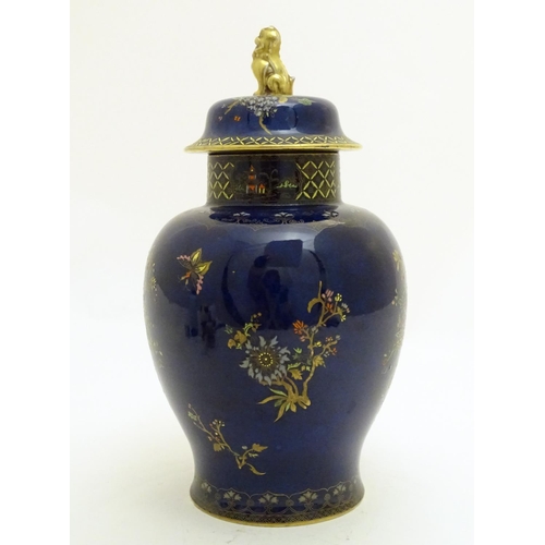 100 - A Wiltshaw and Robinson Carlton Ware baluster vase and cover decorated with flowers, with a blue gro... 