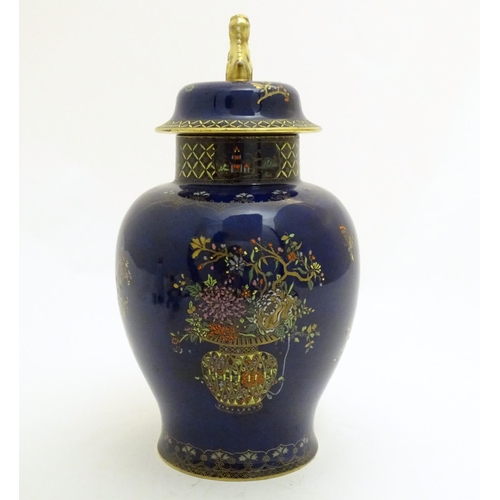 100 - A Wiltshaw and Robinson Carlton Ware baluster vase and cover decorated with flowers, with a blue gro... 