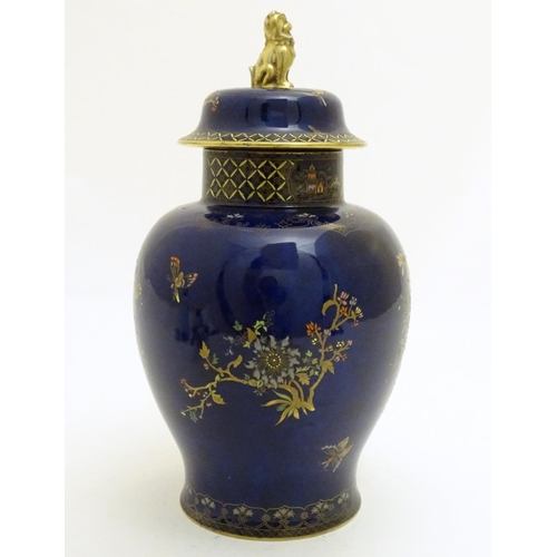 100 - A Wiltshaw and Robinson Carlton Ware baluster vase and cover decorated with flowers, with a blue gro... 