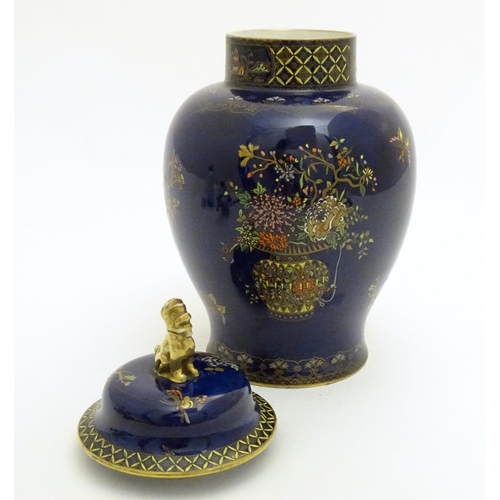 100 - A Wiltshaw and Robinson Carlton Ware baluster vase and cover decorated with flowers, with a blue gro... 