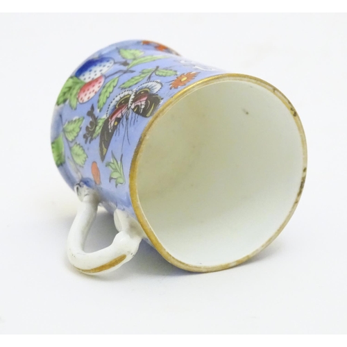 102 - A 19thC coffee cup with hand painted decoration depicting butterflies, strawberries and foliage. App... 