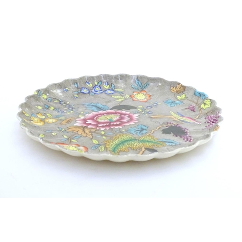 104 - A Copeland plate with scalloped rim with floral, foliate and bird detail. Impressed marks under. App... 