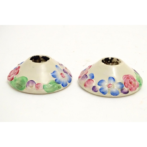 106 - A pair of Clarice Cliff candle holders from the My Garden Verdant series with relief floral decorati... 