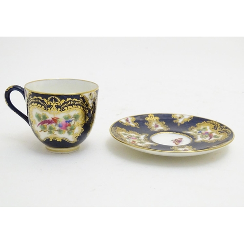 110 - A Royal Worcester tea cup and saucer decorated blue scale ground and vignette panels hand painted wi... 