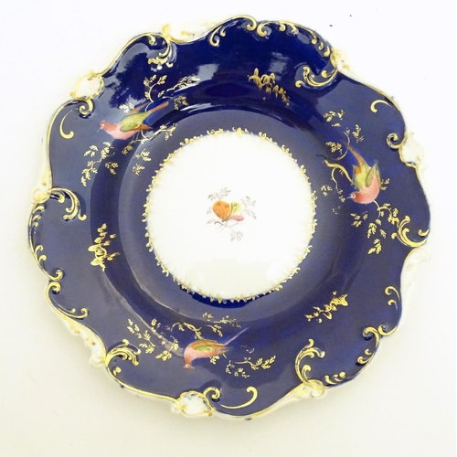 112 - Two 19thC dessert plates with cobalt blue ground scrolling gilt highlights and hand painted bird and... 