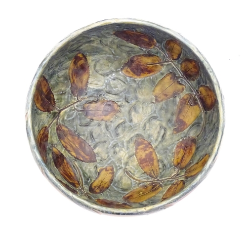 114 - A Royal Doulton stoneware bowl with banded autumnal foliate leaf decoration on a mottled blue ground... 