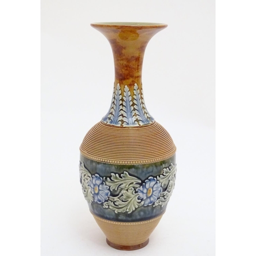 115 - A Doulton Lambeth stoneware vase with a flared rim, ribbed body and banded section with scrolling fl... 