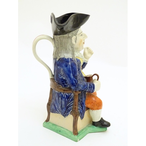 120 - A large Toby jug formed as a seated gentleman in a tricorn hat with a tankard of ale. Approx. 10 3/4... 