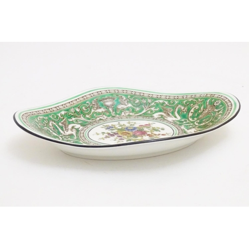 123 - A Wedgwood dish of lozenge form in the pattern Florentine with a central floral motif and green grou... 